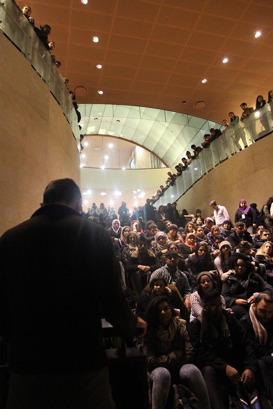 A speaker talks to the crowd of students participating in a vigil for the victims of the Chapel Hill shooting.