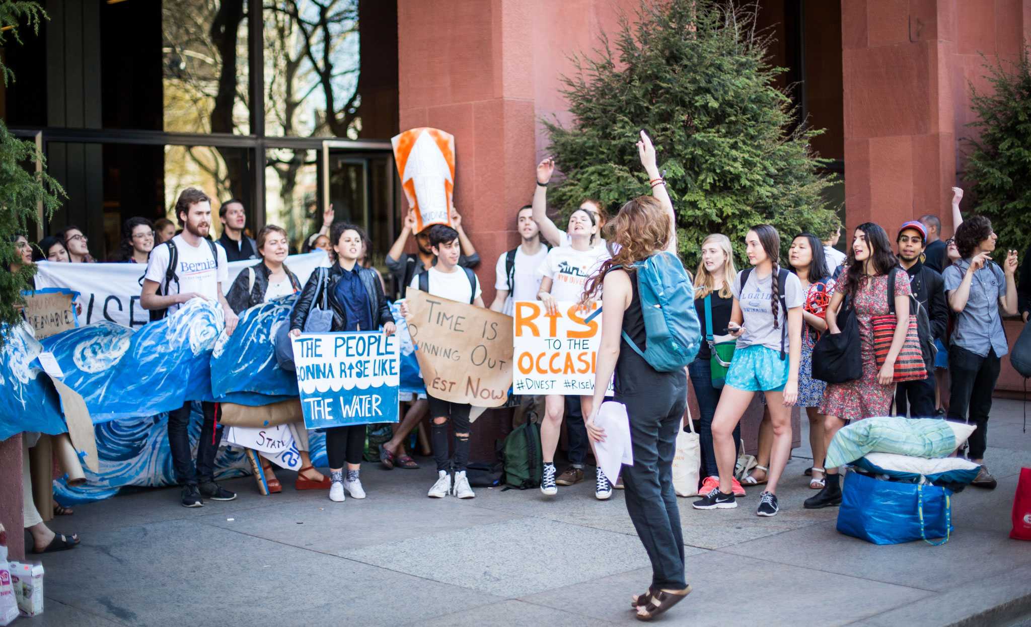 Members of NYU Divest rally outside of Bobst Library in April.