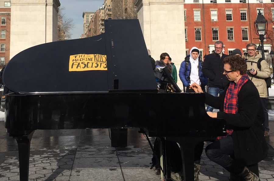 A+pianist+who+frequents+Washington+Square+Park+altered+his+instrument+with+a+sign+that+reads+%22this+machine+kills+fascism.%22+He+played+in+front+of+the+arch+as+people+gathered+to+record+his+music.