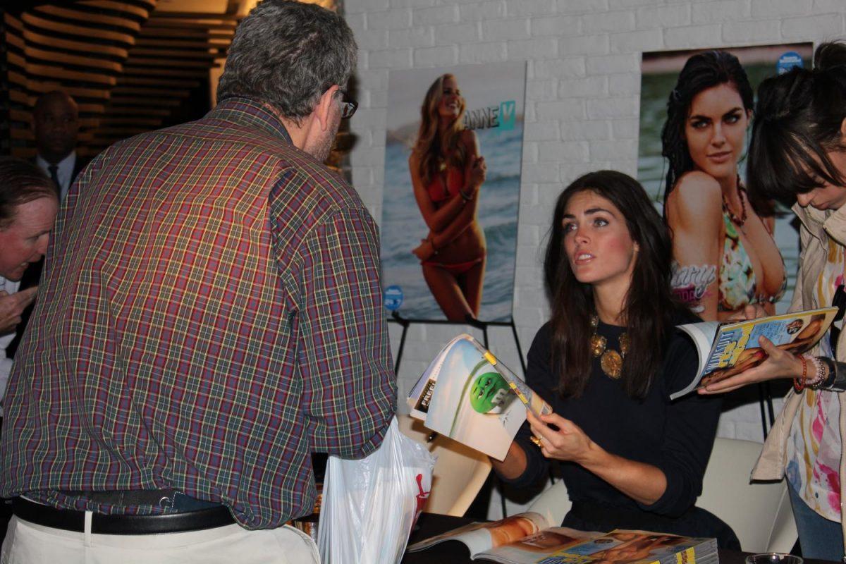 Model+Hilary+Rhoda+signs+a+copy+of+the+yearly+Sports+Illustrated+swimsuit+issue+for+a+man+at+the+Cosmopolitan+of+Las+Vegas.+Many+people+feel+this+issue+promotes+sexual+objectification.%0A