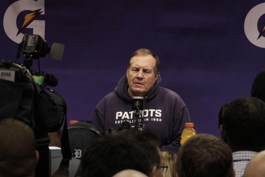 New+England+Patriots+coach+Bill+Belichick+speaking+at+the+podium+during+Super+Bowl+XLIX+media+day%2C+January+2015.
