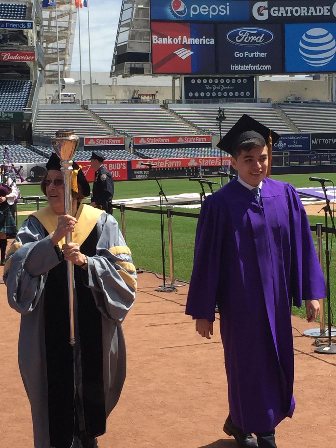Azizjon Azimi (right) at the Class of 2016 commencement ceremony. Azimi was the youngest graduate in his class and is currently pursuing concurrent degree program at Harvard and Stanford.