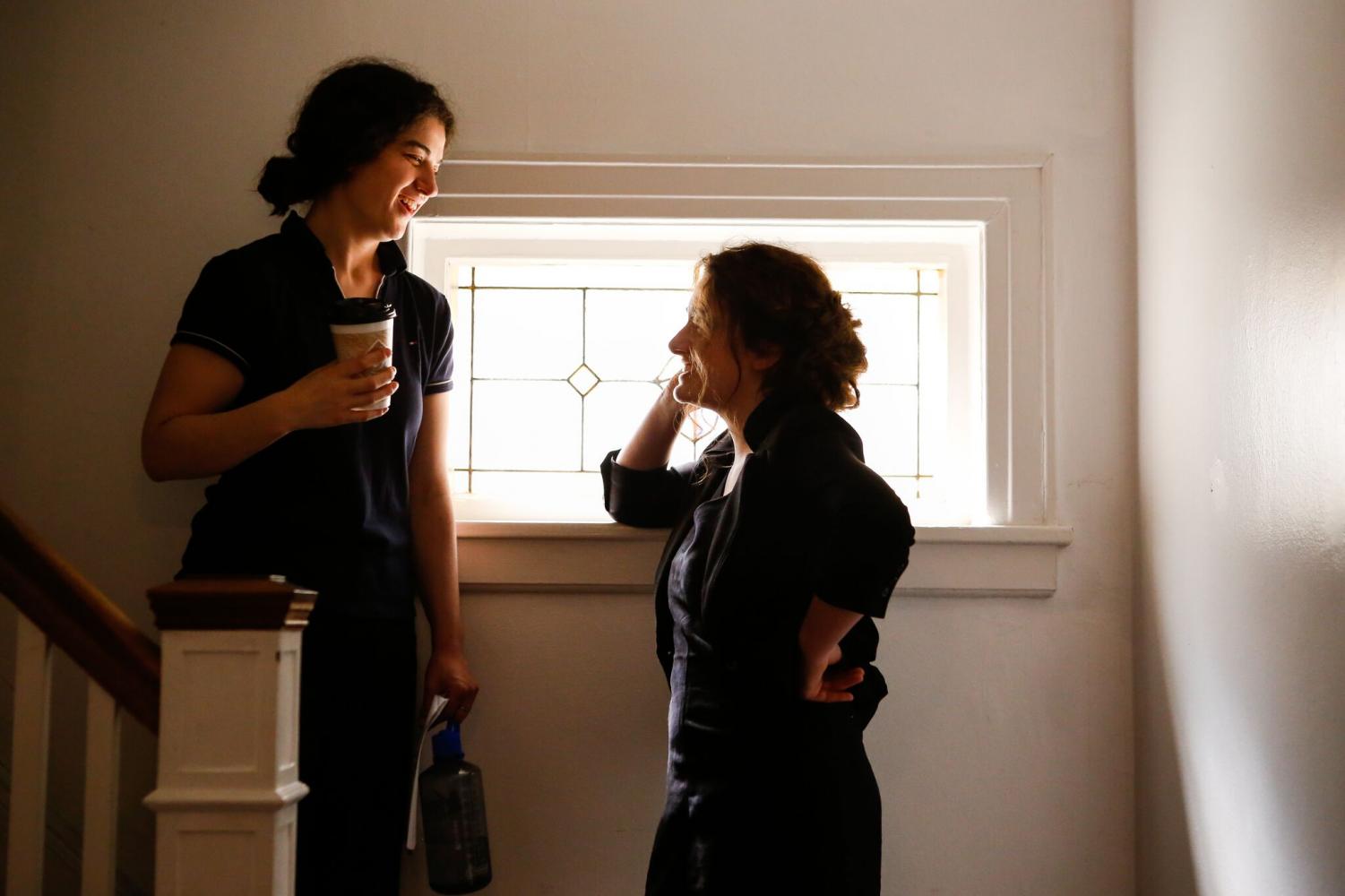 Emma Seligman and Rachel Sennott talking on the set of
