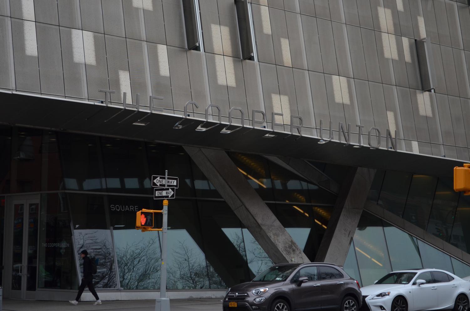 A pedestrian walks past 41 Cooper Square, which houses many of The Cooper Union's classrooms and studios.