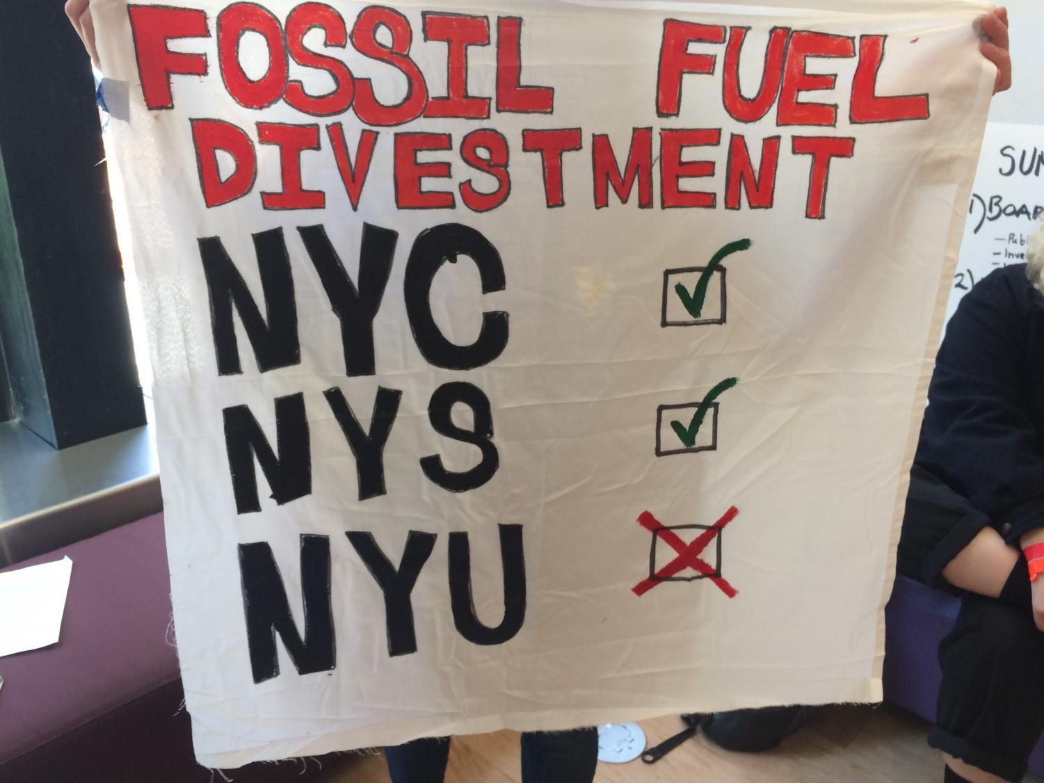Demonstrators displayed posters advocating for fossil fuel divestment and improved student representation.