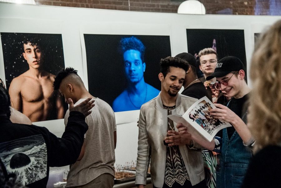 At+the+release+party+for+Survivors+Magazine%2C+two+attendees+look+over+the+new+issue.+The+magazine+uses+photography+as+a+way+to+increase+awareness+of+sexual+assault.