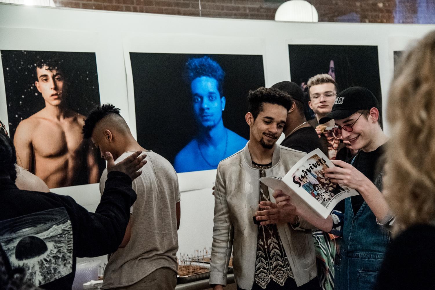 At the release party for Survivors Magazine, two attendees look over the new issue. The magazine uses photography as a way to increase awareness of sexual assault.