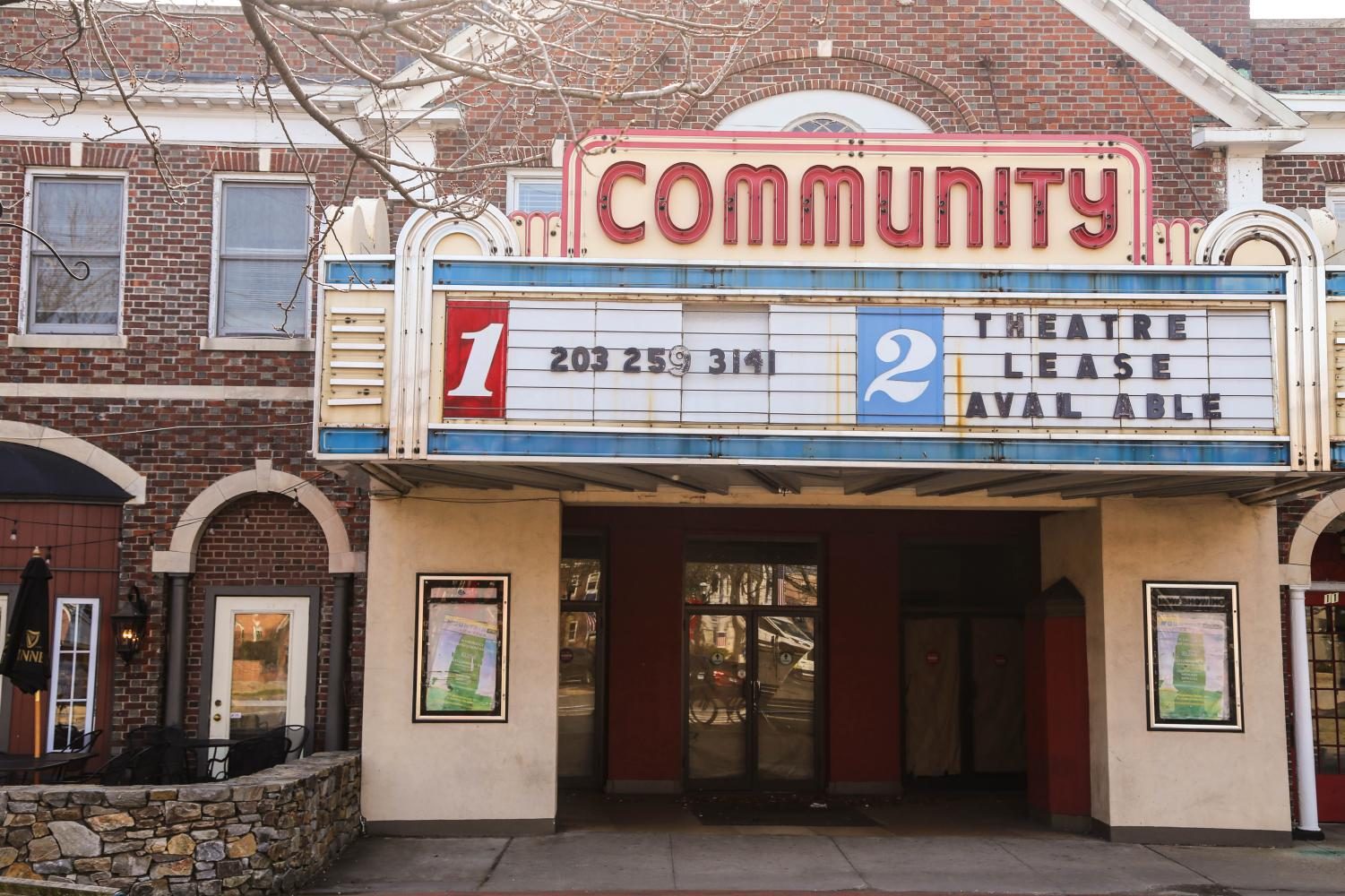 A closed down movie theater in the center of town.